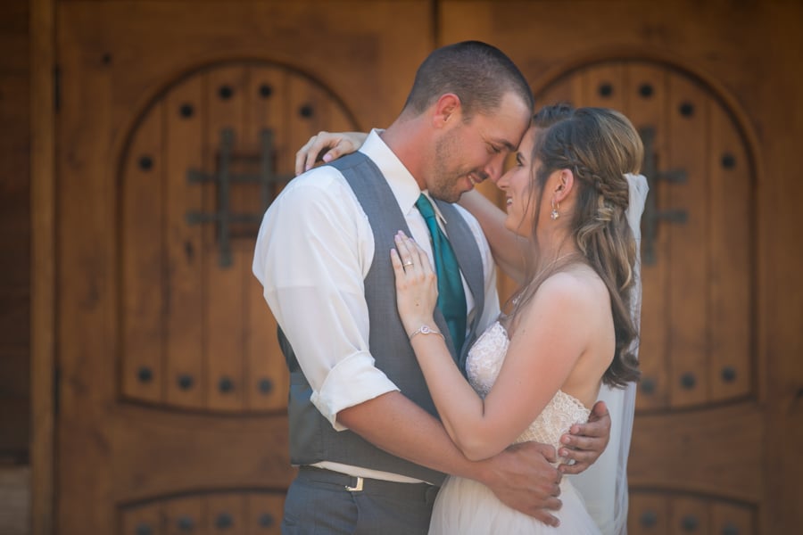 bride and groom infront of wood doors